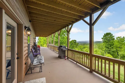 a view of balcony with couch and chairs