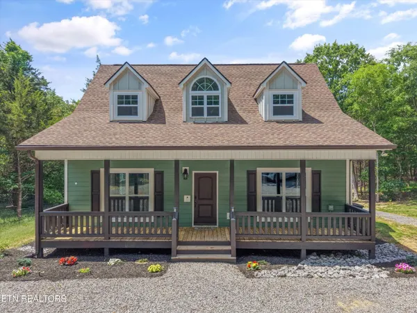 a view of a house with a yard and furniture
