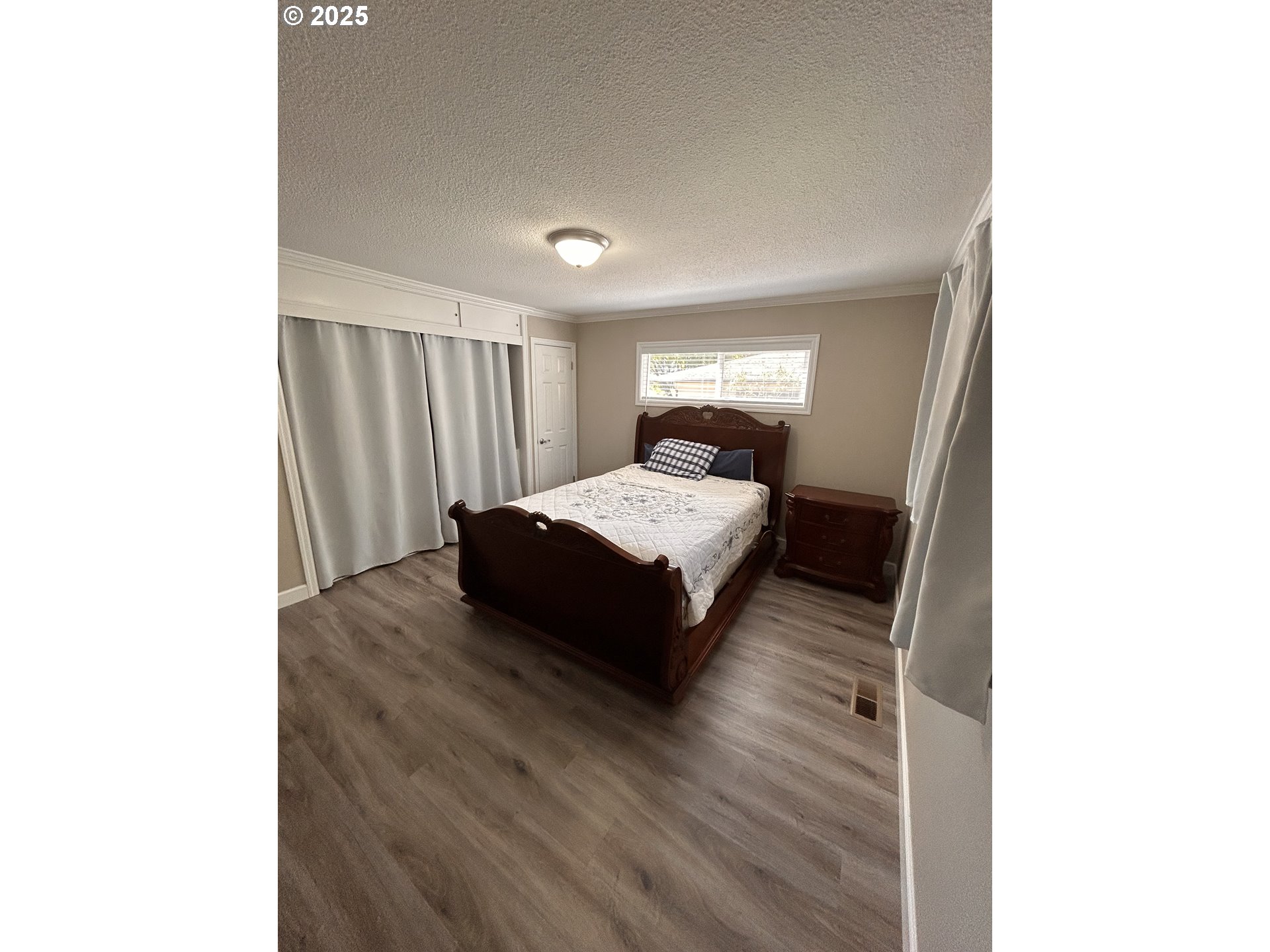 1305 Northeast Newall Road Newberg, OR 97132 - Photo 11 of 21 a spacious bedroom with a bed and a mirror