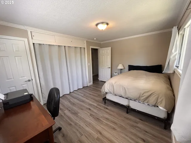 a spacious bedroom with a bed and a window