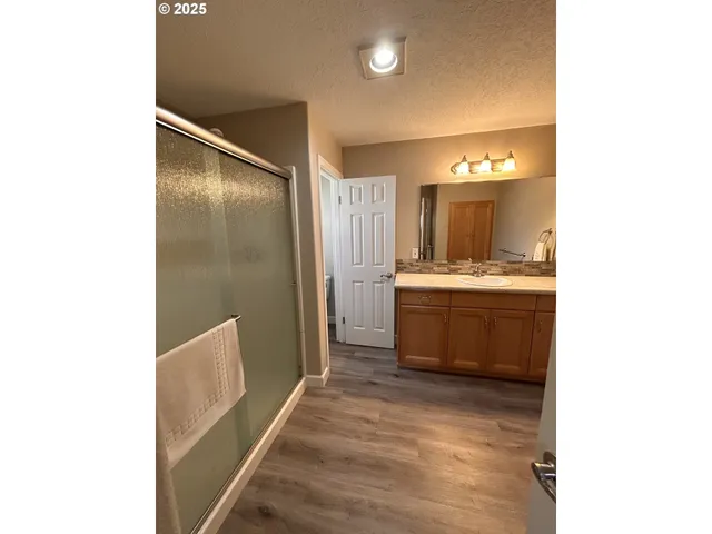 a spacious bedroom with a bed and a mirror