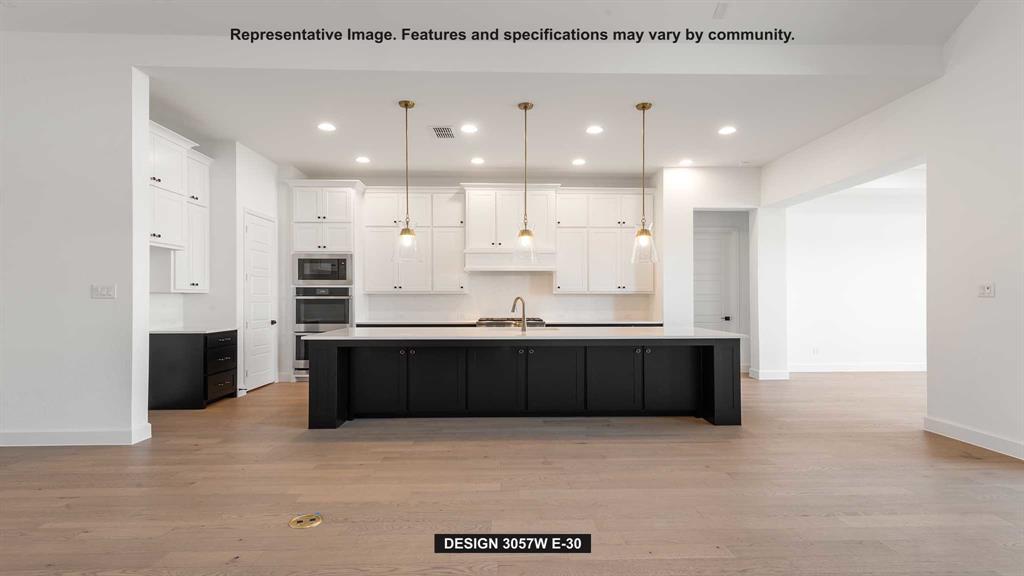 1908 Vantage Drive Rockwall, TX 75087 - Photo 2 of 17 a large kitchen with stainless steel appliances kitchen island granite countertop a refrigerator a sink dishwasher and a stove with wooden floor