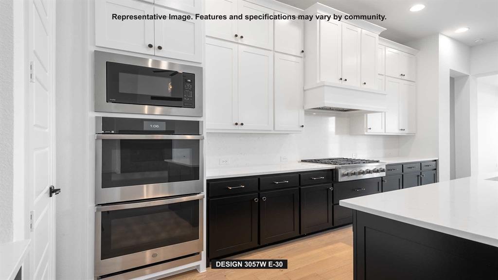 1908 Vantage Drive Rockwall, TX 75087 - Photo 7 of 17 a kitchen with stainless steel appliances white cabinets and stove
