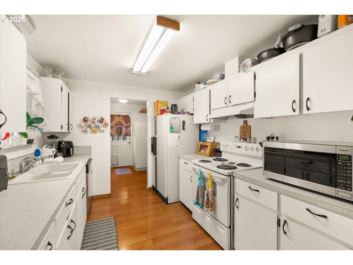 904 South Magnolia Street Cornelius, OR 97113 - Photo 17 of 28 a kitchen with white cabinets and white appliances