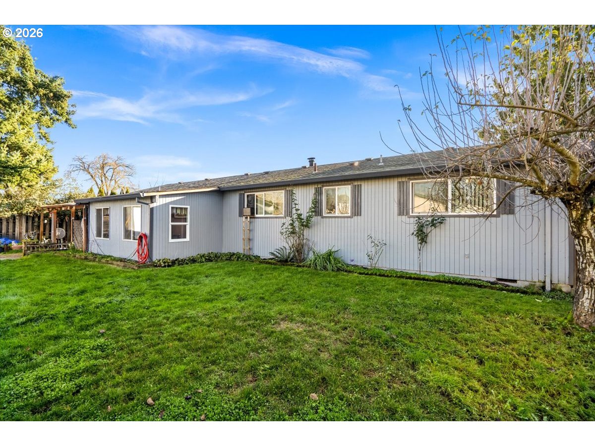 904 South Magnolia Street Cornelius, OR 97113 - Photo 4 of 28 a view of a backyard with plants and large trees