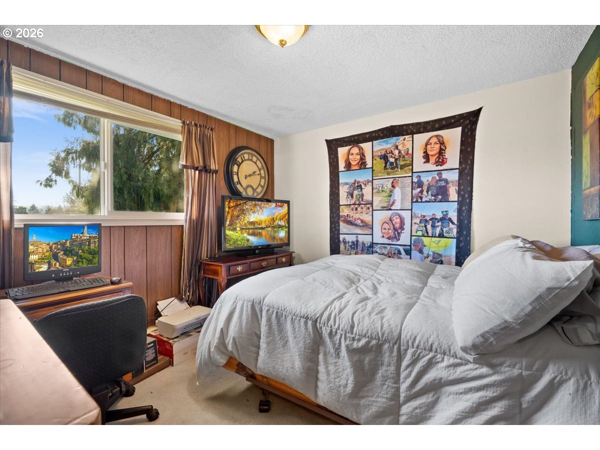 904 South Magnolia Street Cornelius, OR 97113 - Photo 8 of 28 a bedroom with a bed a dresser next to a window
