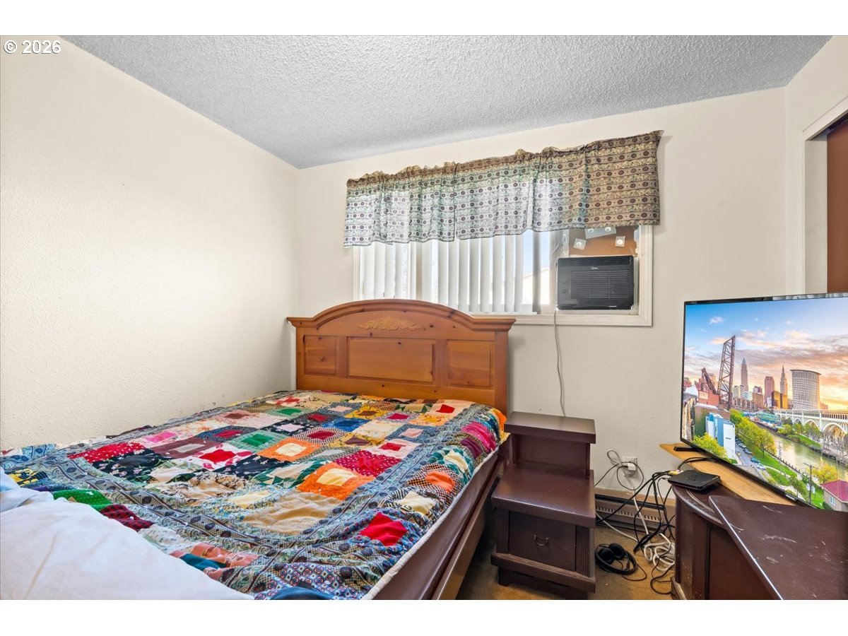 904 South Magnolia Street Cornelius, OR 97113 - Photo 9 of 28 a bedroom with a bed and a table in it