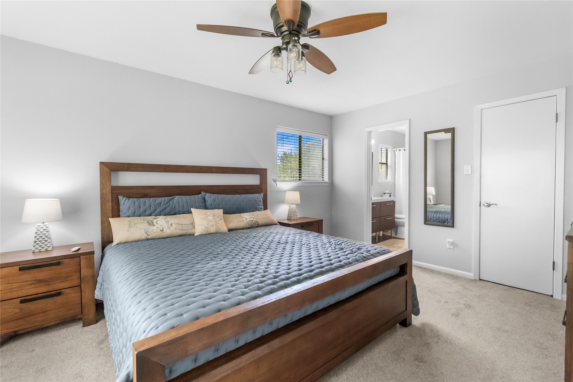 210 Teeoff, Unit B Horseshoe Bay, TX 78657 - Photo 18 of 38 A tranquil primary bedroom suite with plush carpeting and private bath access.