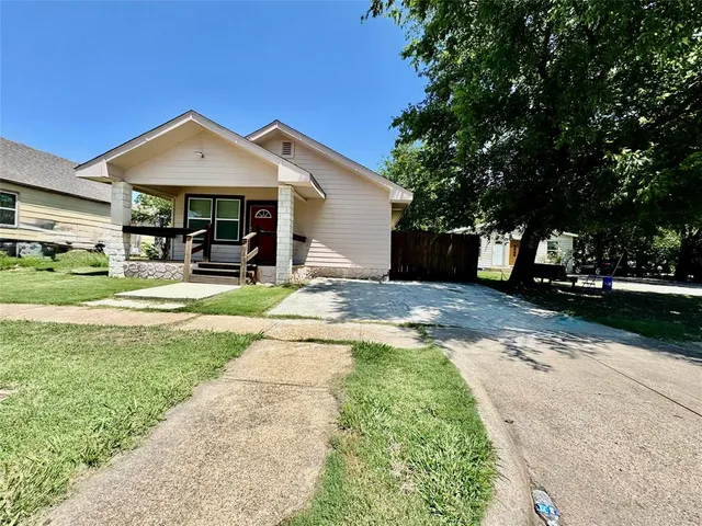 a front view of a house with a yard and porch