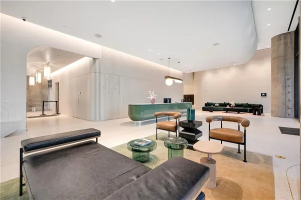 a living room with furniture and kitchen view