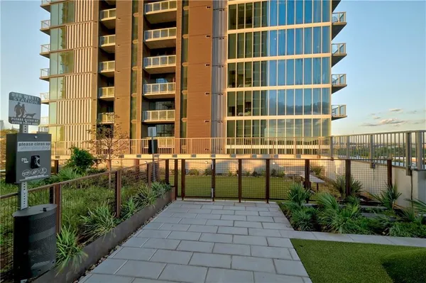 a front view of a building with a garden