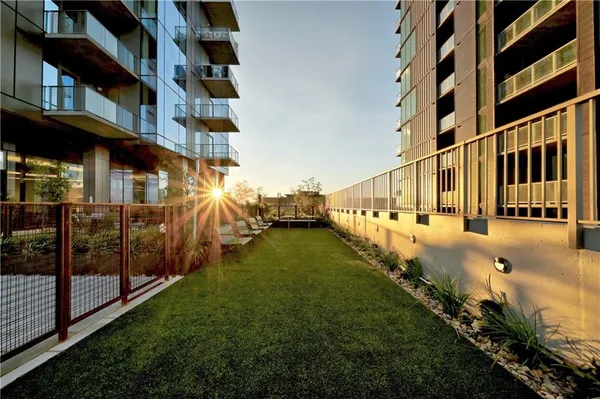 a view of building with yard and large trees