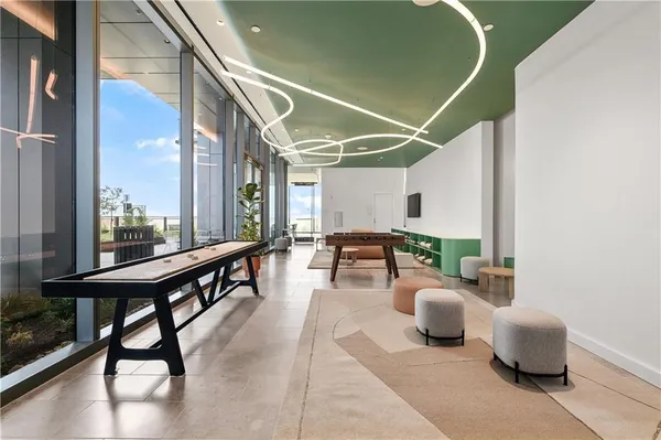 a lobby with furniture and view of living room