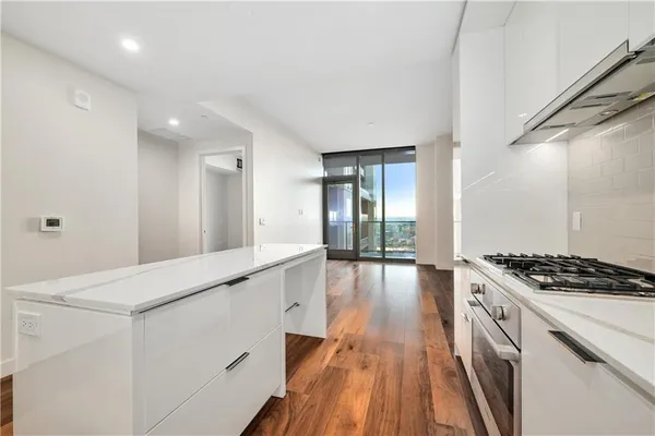 a kitchen with granite countertop a stove and a sink
