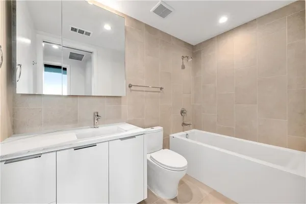 a bathroom with a sink a toilet and bathtub