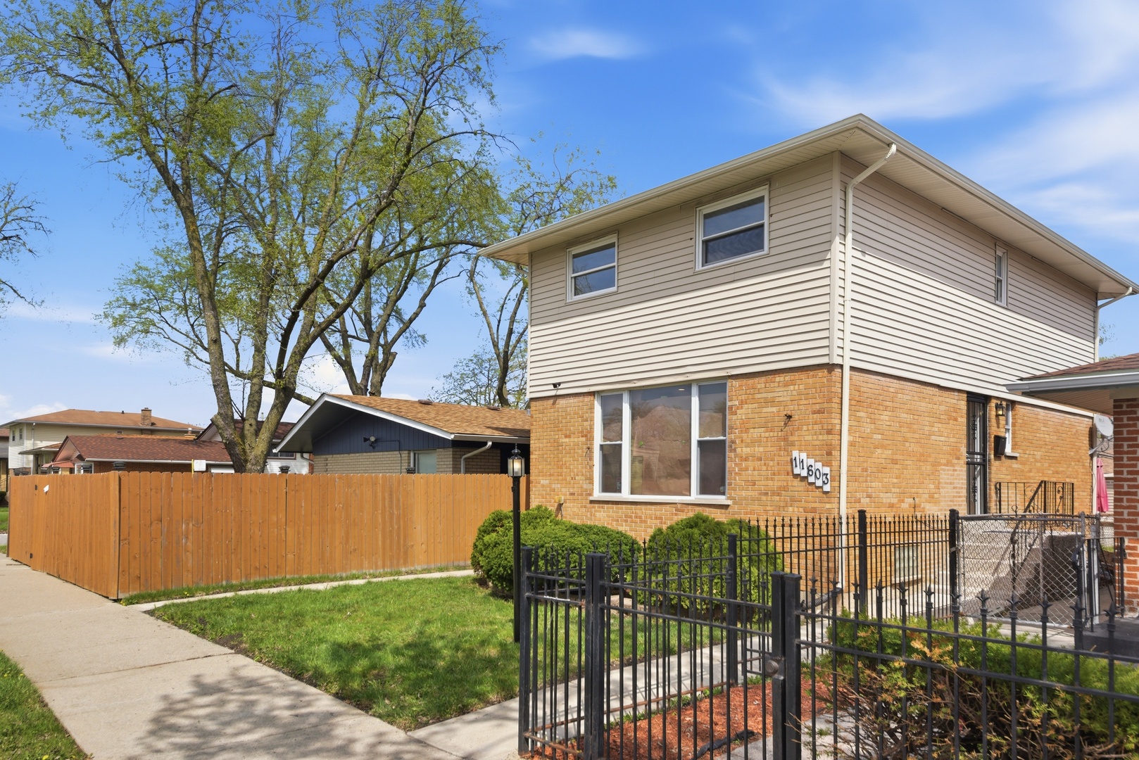 11603 South Loomis Street Chicago, IL 60643 - Photo 2 of 26 a front view of a house with a yard