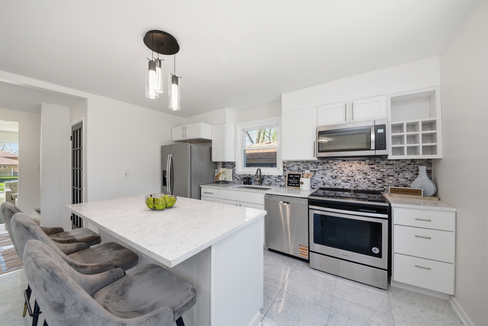 11603 South Loomis Street Chicago, IL 60643 - Photo 8 of 26 a kitchen with a sink a stove and chairs