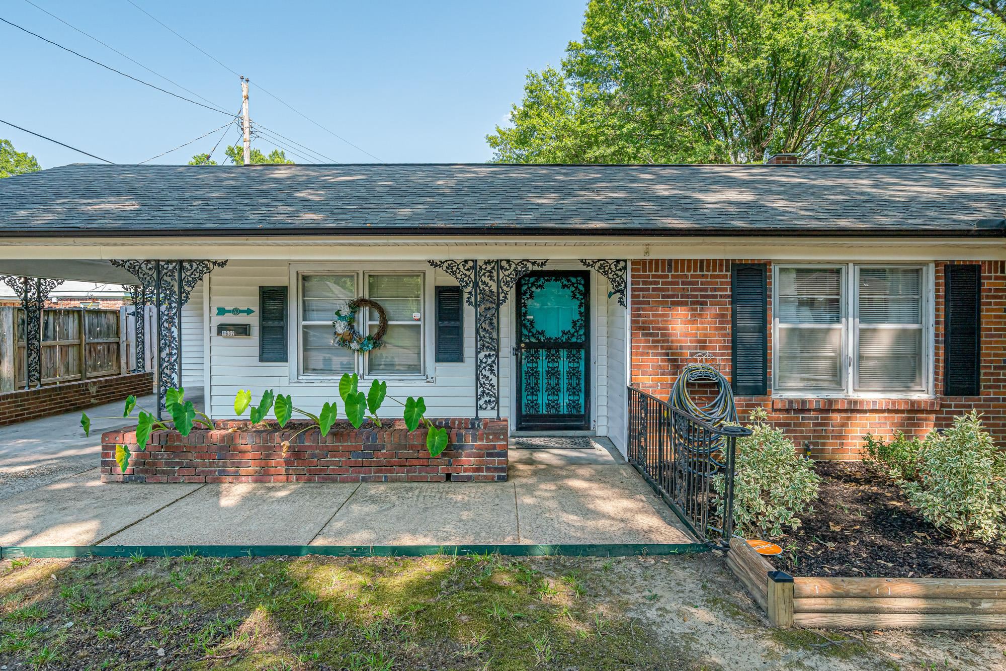 1632 South Perkins Road Memphis, TN 38117 - Photo 1 of 25 a front view of a house with garden