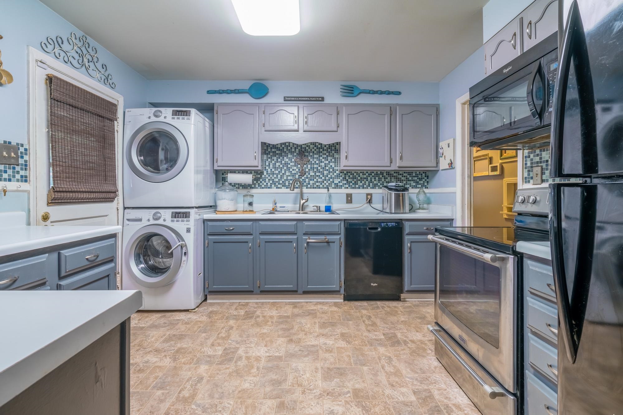 1632 South Perkins Road Memphis, TN 38117 - Photo 15 of 25 a kitchen with a stove top oven sink and cabinets