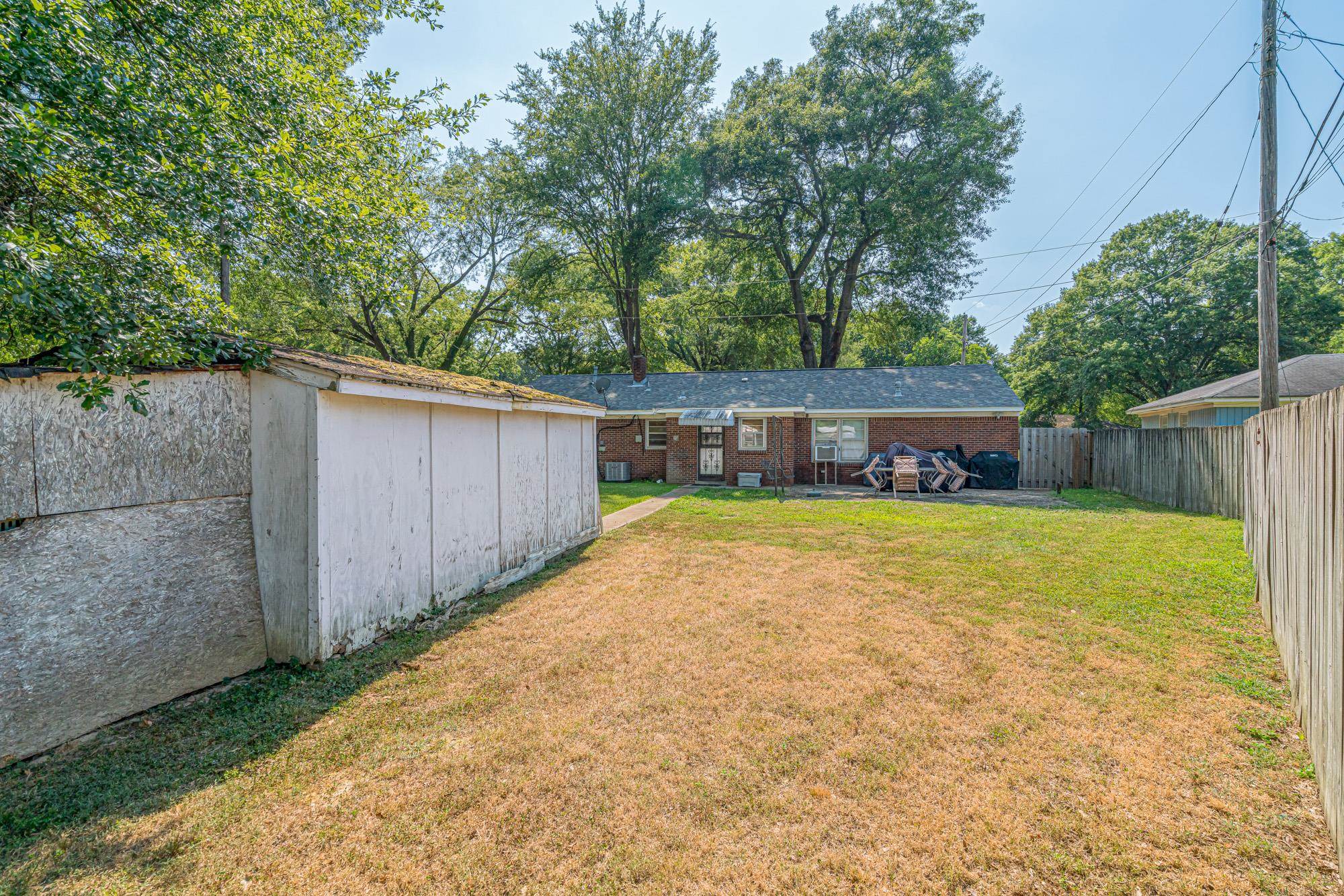 1632 South Perkins Road Memphis, TN 38117 - Photo 24 of 25 a view of a backyard with a small cabin