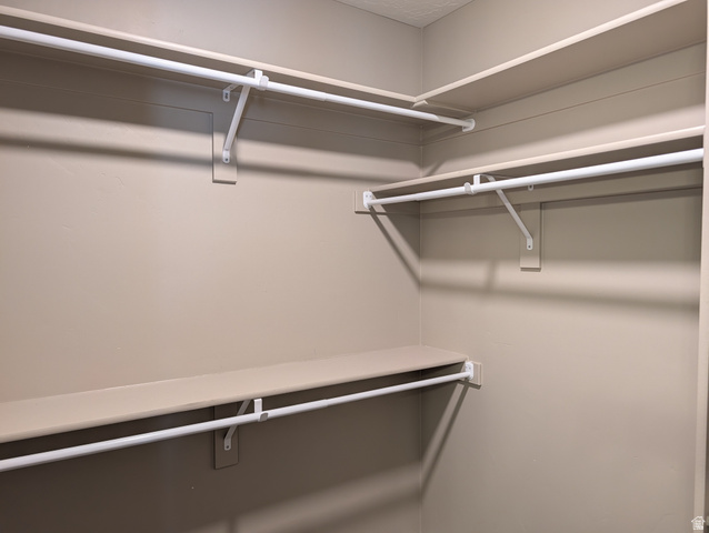 171 South Mustang Road East Grantsville, UT 84029 - Photo 16 of 41 Built-in custom shelving and hanging rods create an organized storage space
