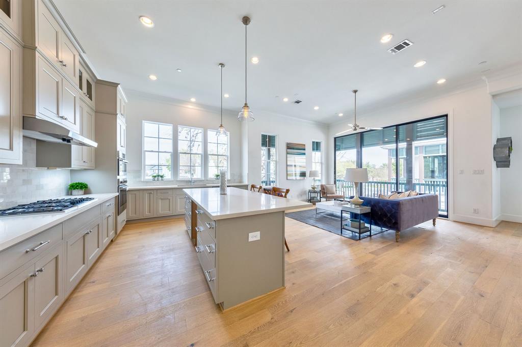 a large kitchen with kitchen island a counter top space a sink a window and stainless steel appliances