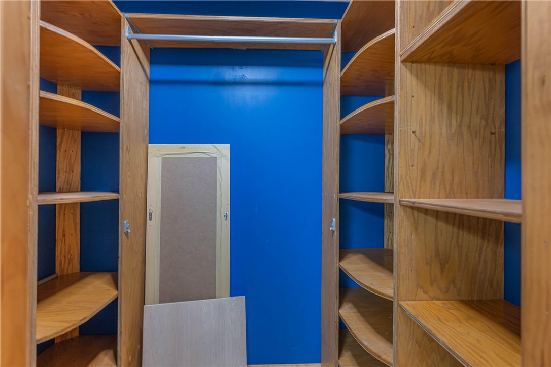 2645 Vance Road St. Paris, OH 43072 - Photo 26 of 35 An organized closet featuring built-in wooden shelving and a convenient hanging rod.