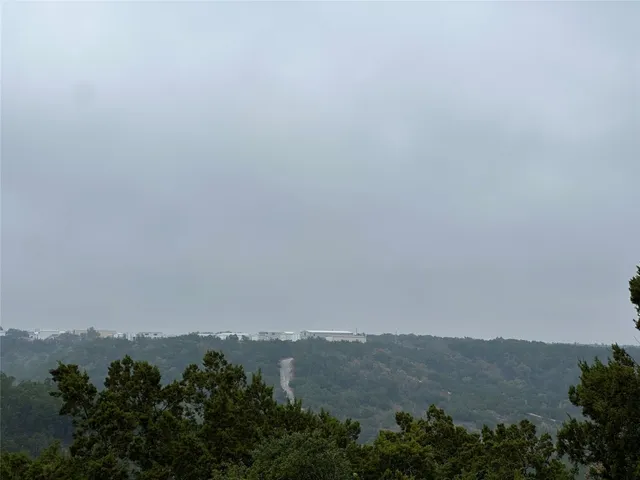 an aerial view of mountain with trees around