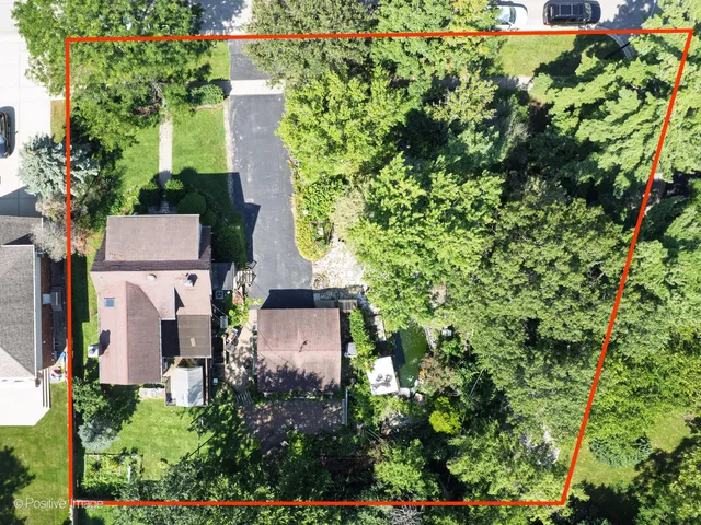 an aerial view of a house with a yard and garden