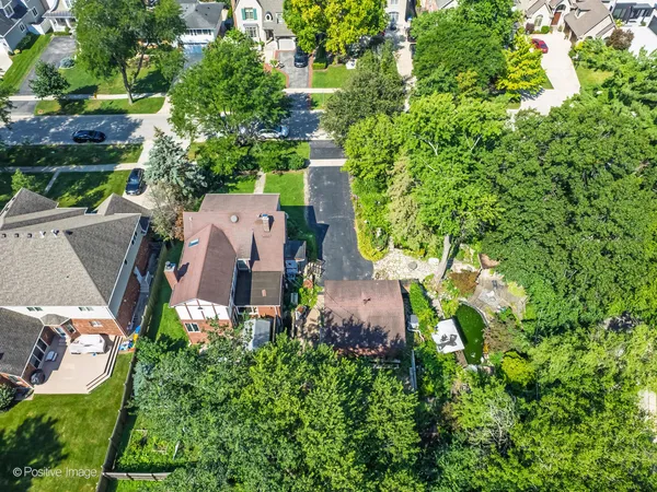 an aerial view of a house with yard swimming pool and outdoor seating