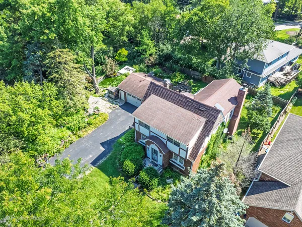 an aerial view of a house with a yard