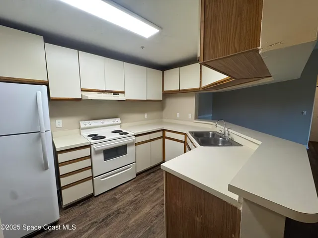 a kitchen with a white cabinets and white appliances