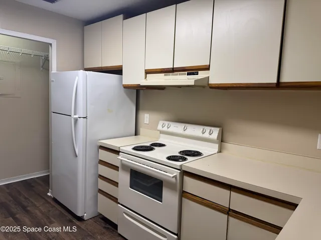 a kitchen with stainless steel appliances a refrigerator and a stove