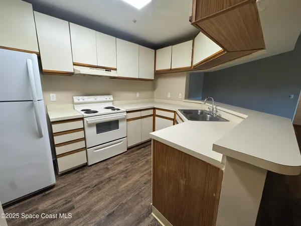 a kitchen with a sink a stove and cabinets
