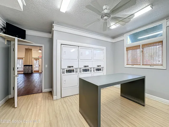 a kitchen with a sink appliances cabinets and a window