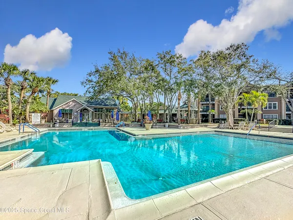 a view of swimming pool and trees in the background