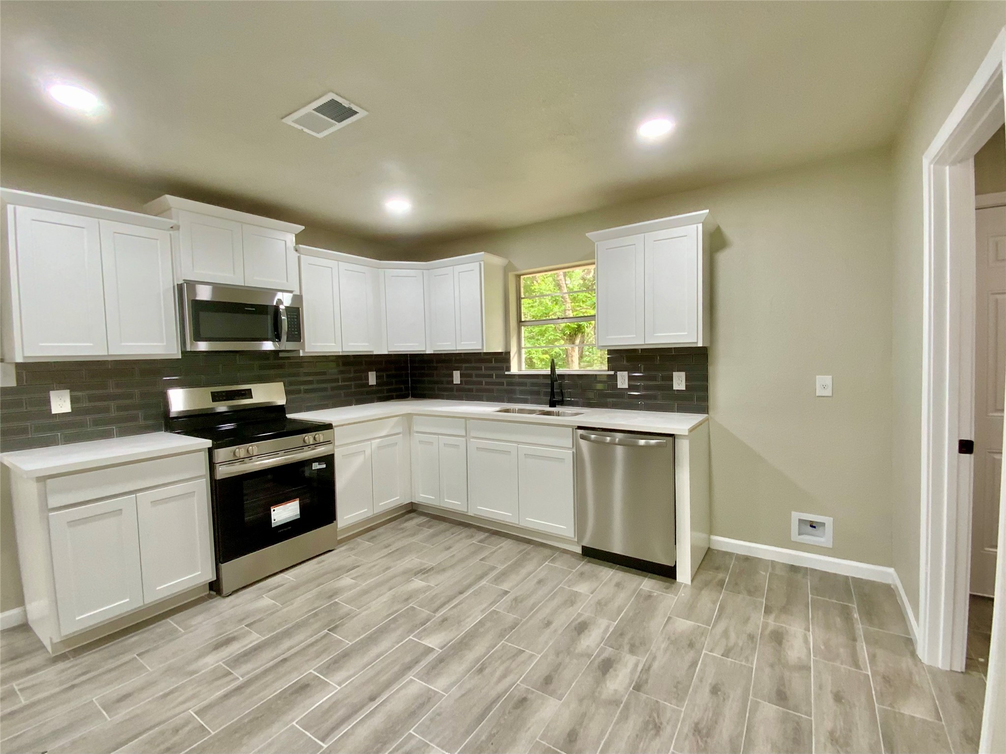 296 Kings Row Street Livingston, TX 77351 - Photo 22 of 35 Kitchen and Side Door to Utility In-House