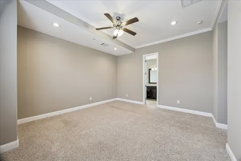 an empty room with windows and chandelier fan
