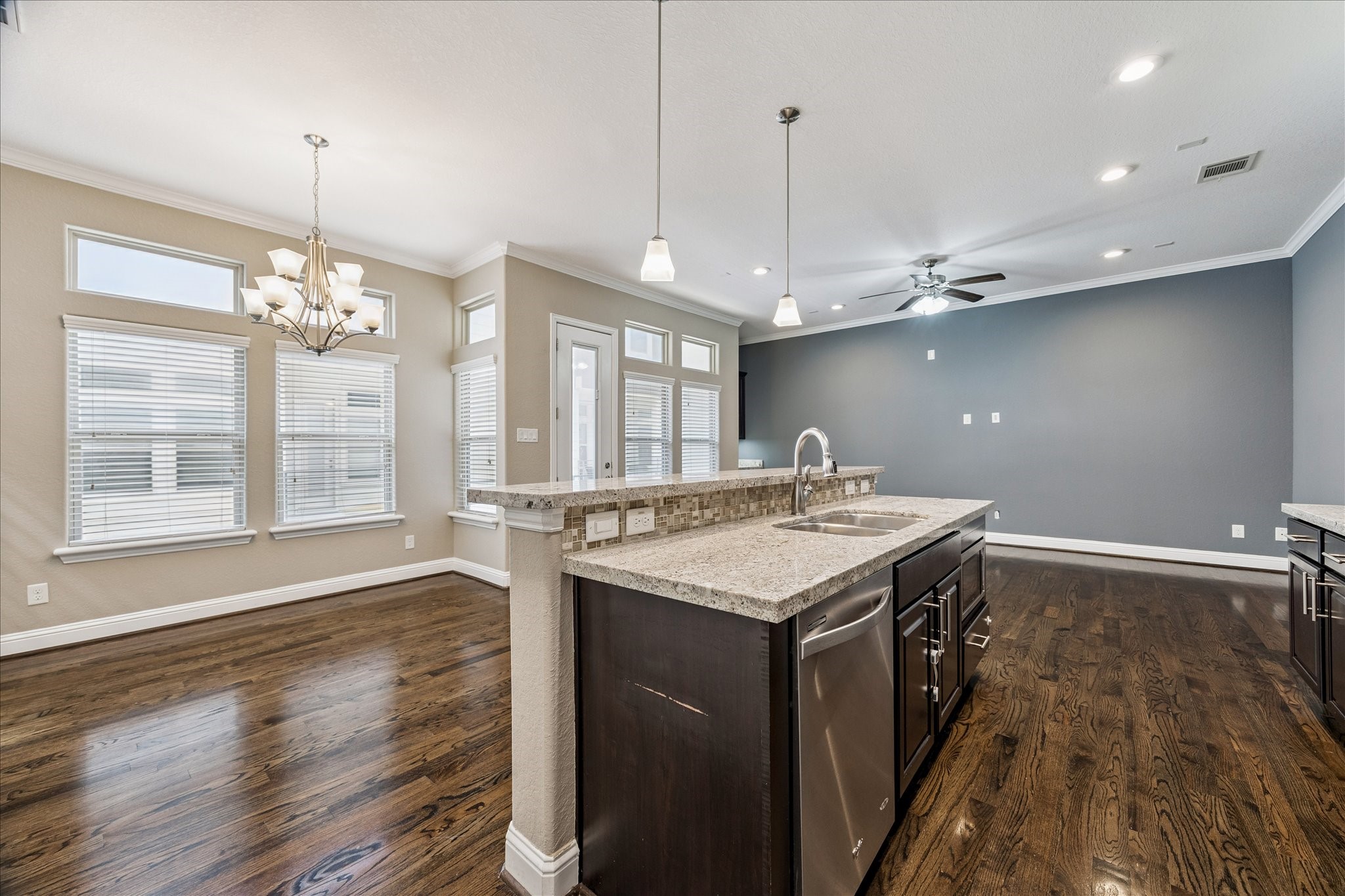 1113 West 18th Street, Unit B Houston, TX 77008 - Photo 7 of 32 a kitchen with a stove a sink dishwasher and a wooden floor