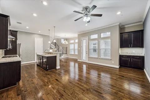 a kitchen with a stove a sink dishwasher and a wooden floor