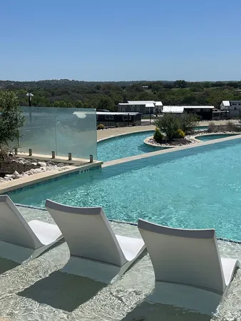 a view of a lake with couches in the back