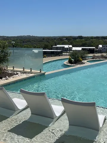 a view of a lake with couches in the back