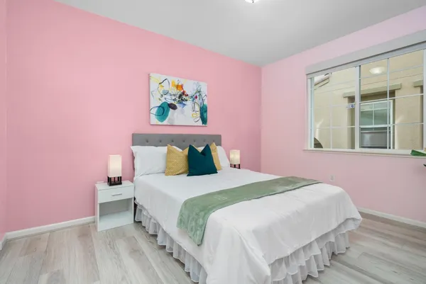 a bedroom with a bed and a window