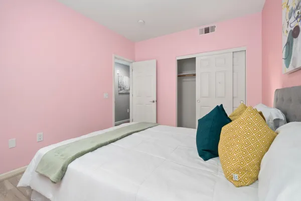 a bedroom with a bed and a closet