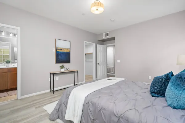 a bedroom with a bed and a flat screen tv