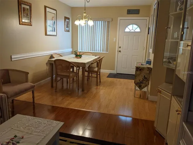 a view of a dining room with furniture and a chandelier