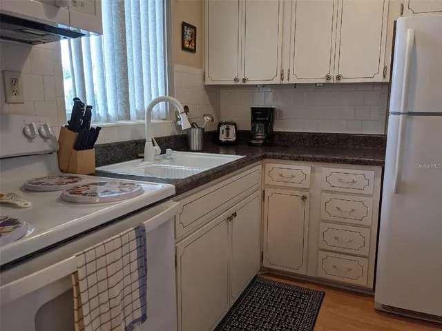 a kitchen with a sink cabinets and window