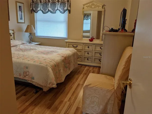 a bedroom with a bed next to a window