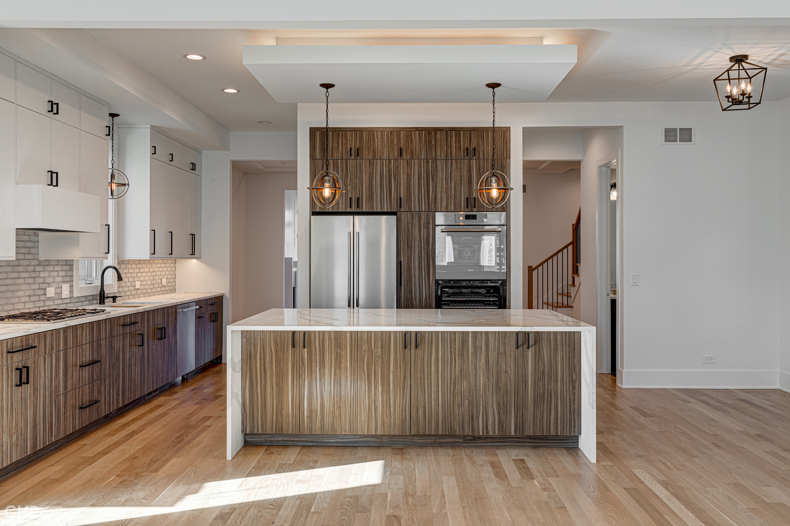 3711 North Spaulding Avenue Chicago, IL 60618 - Photo 12 of 35 a large kitchen with stainless steel appliances a large counter top a sink a stove and a refrigerator