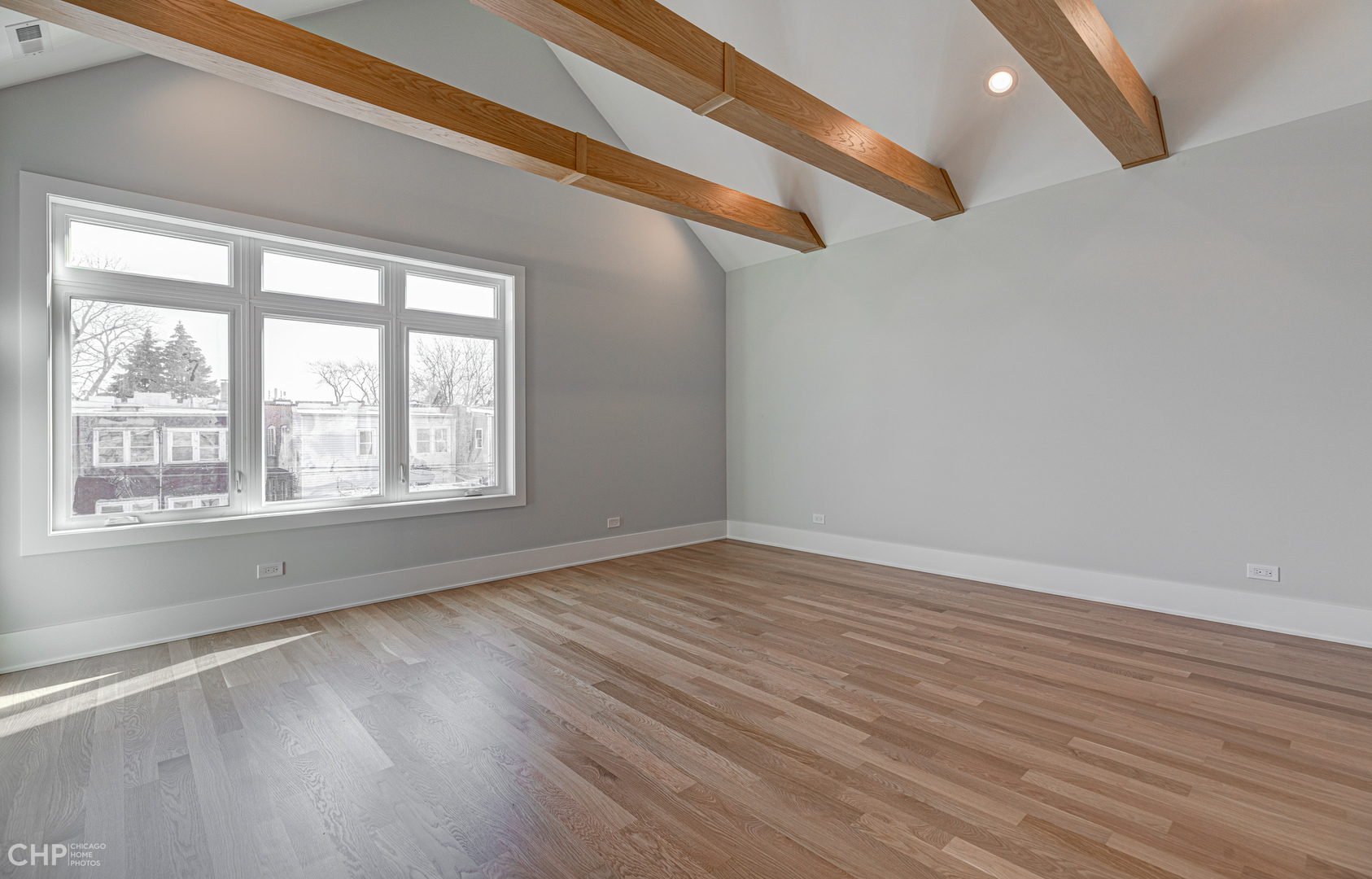 3711 North Spaulding Avenue Chicago, IL 60618 - Photo 17 of 35 a view of an empty room with wooden floor and a window